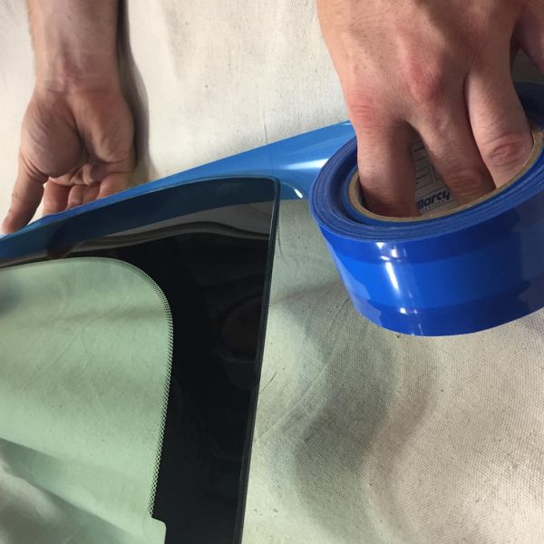 Marcy edge tape being applied to auto glass